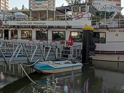 a boat is docked next to a building