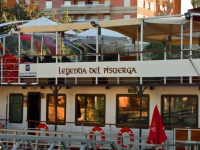 a group of people sitting at a table in front of a building