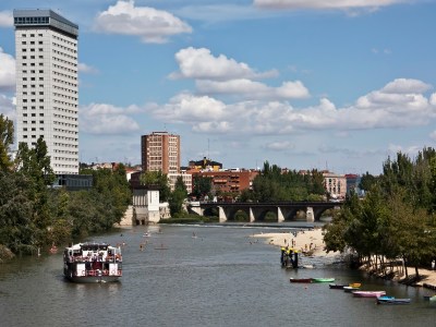 a small boat in a body of water with a city in the background
