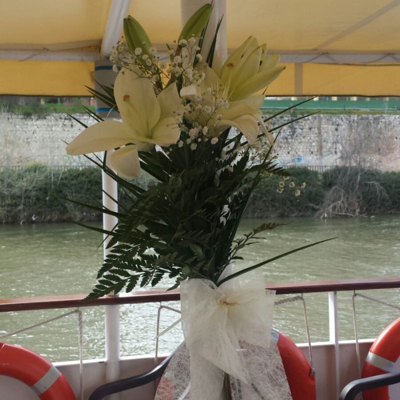 a vase filled with flowers sitting on a chair