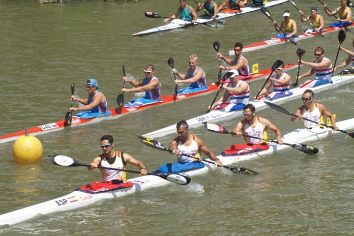 a group of people rowing a boat in the water